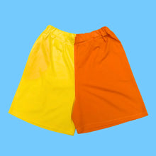 Load image into Gallery viewer, A pair of sustainable shorts in two tone yellow and bright orange

