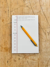 Load image into Gallery viewer, Notebook with checklist and pen on a wooden surface
